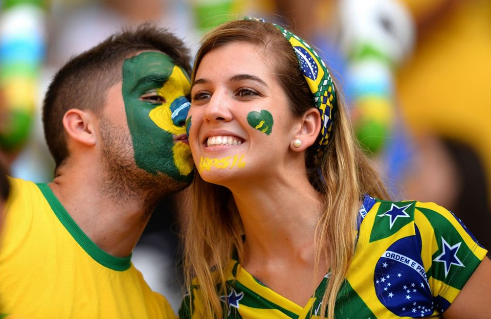 Brazilian couple kissing during football match